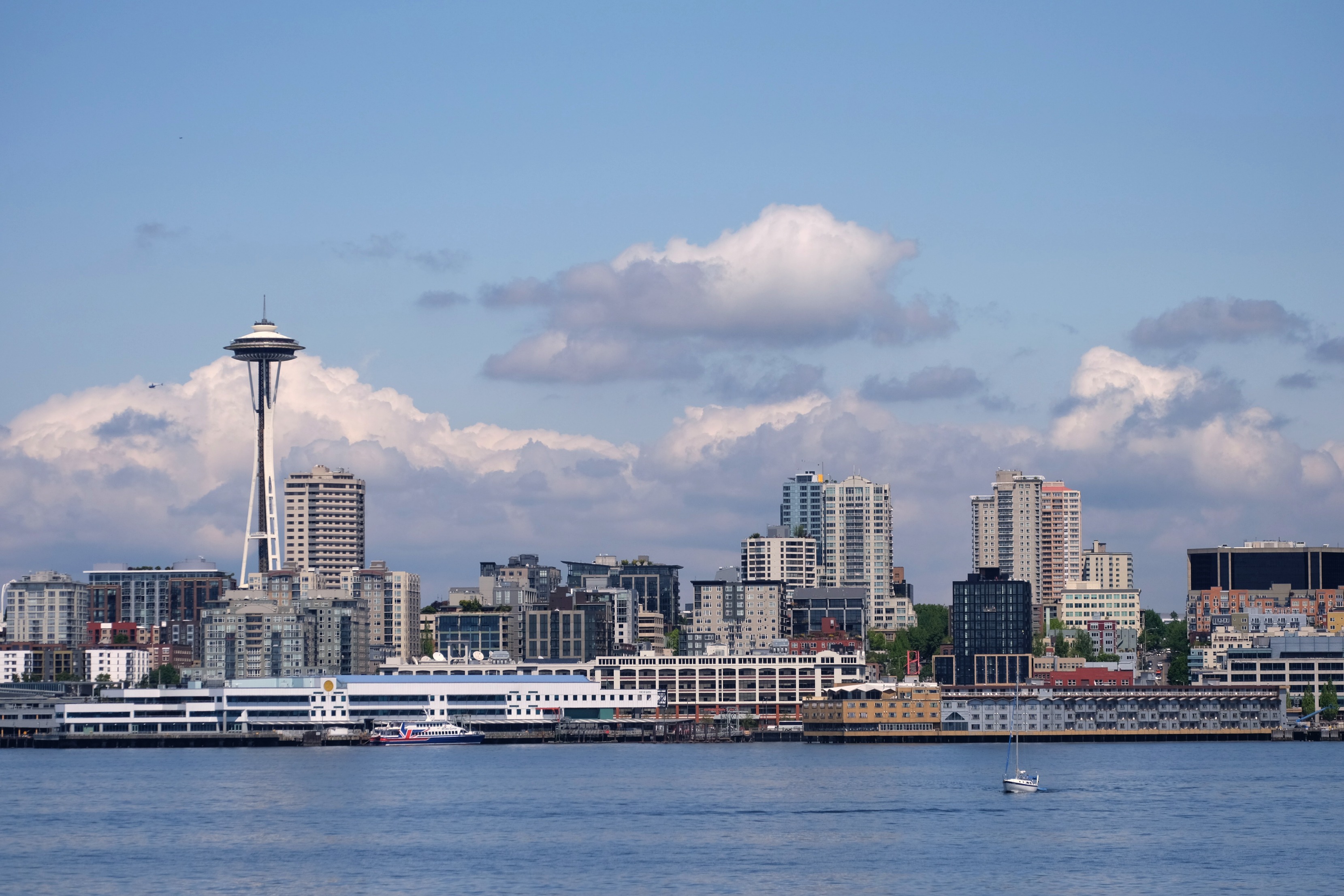 seattle space needle clouds horizon ferry water puget sound cityscape buildings